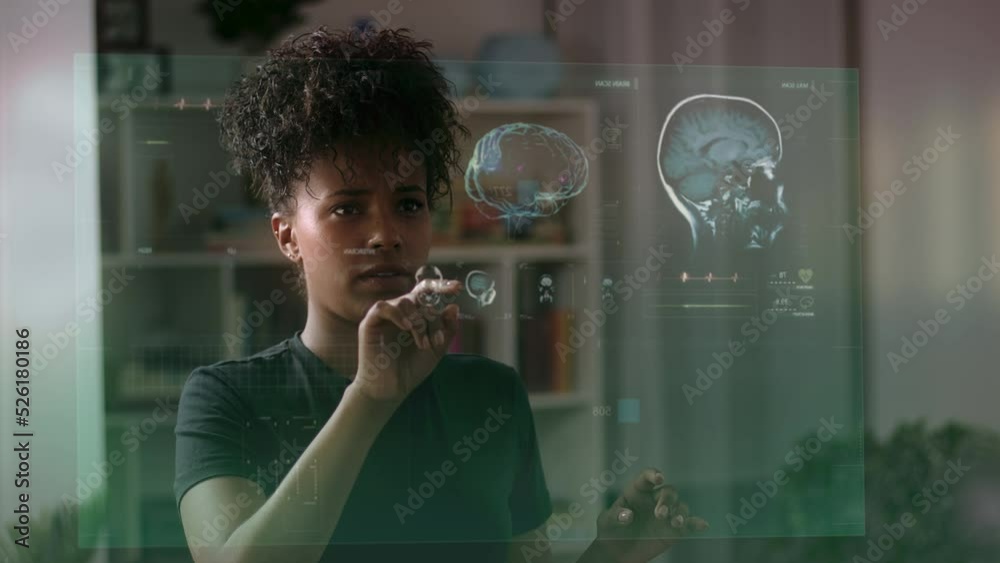 

 African American Female Doctor or Scientist Looking at Patient Information with Augmented Reality or Virtual Reality. Holographic Animation Futuristic Medical Charts. MRI, Brain, DNA.