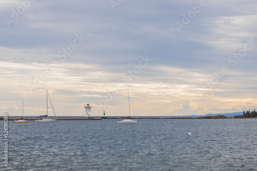 Sailboats in the bay and Grand Marais Lighthouse and Grand Marais Lower Range Lighthouse in background on Lake Superior  Michigan
