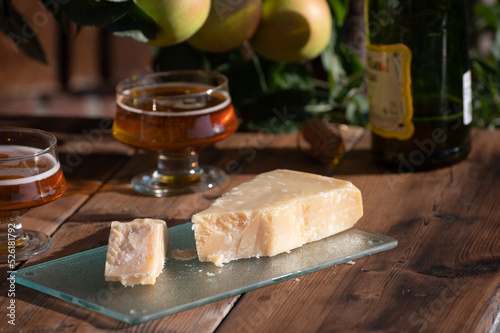 Cheese pairing with drinks, parmigiano reggiano or parmesan cheese and French apple cider served outdoor