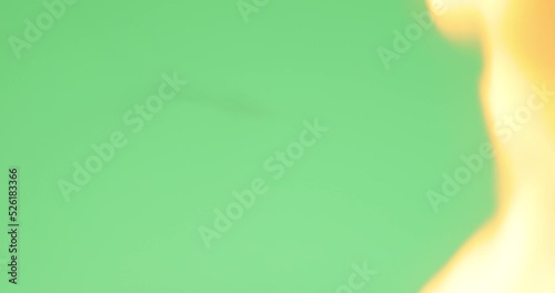 A photo or film film melts and burns in a fire on a green screen. Transition.