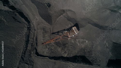 Top view to Career walking excavator removes waste rock, digging out layer of useful material. Coal quarry in Russia.
