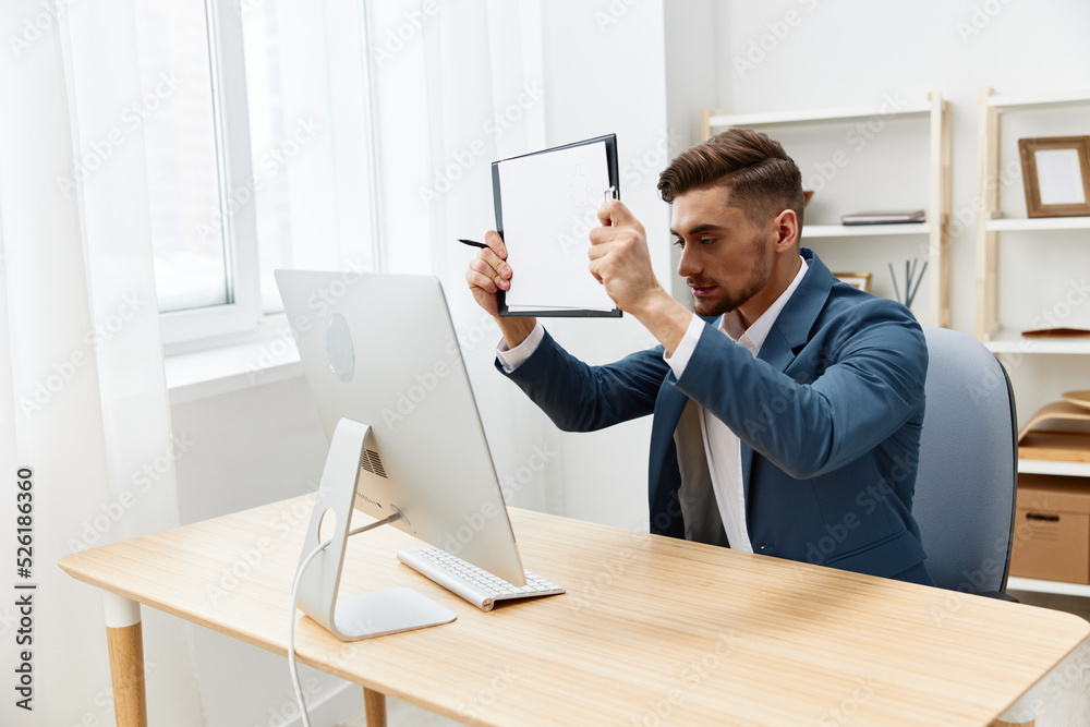 Naklejka premium a man in a suit sitting at the computer work boss documentation isolated background