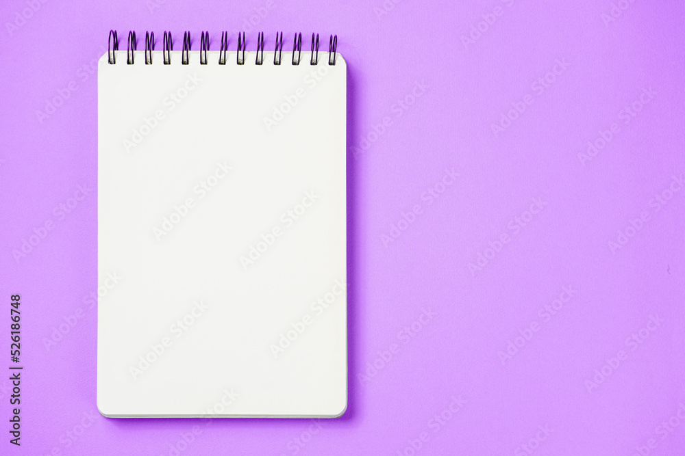 School notebook on a paper pink background, spiral notepad and craft cardboard pen School notebook on a paper pink background, spiral notepad and craft cardboard pen