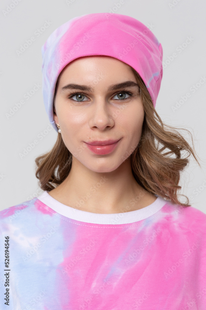 Beautiful woman with a Snood Scarf around her neck in the winter hat. Girl in spring clothes, warm sweatshirt Beautiful woman with a Snood Scarf around her neck in the winter hat. Girl in spring clothes, warm sweatshirt