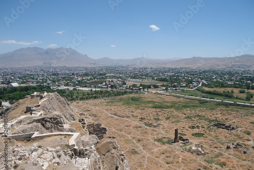 Modern Van city panorama view from Van castle with Urartu ruins. Massive wall and towers of Van Fortress. Fortress was founded in 9 century BC by Urartians and reinforced in medieval by Turks. 