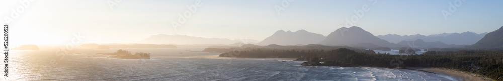 Waves on the Pacific Ocean on a sandy and rocky beach. West Coast. Sunny Summer Sunset. Cox Bay, Tofino, Vancouver Island, BC, Canada. Canadian Nature Background Panorama