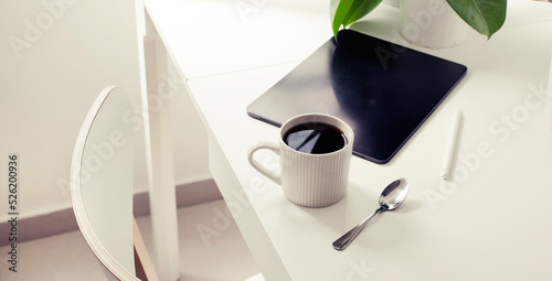 workplace background with cup of coffee and tablet over white table