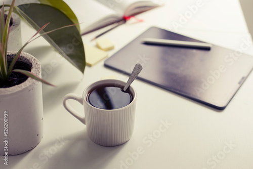 workplace background with cup of coffee and tablet over white table