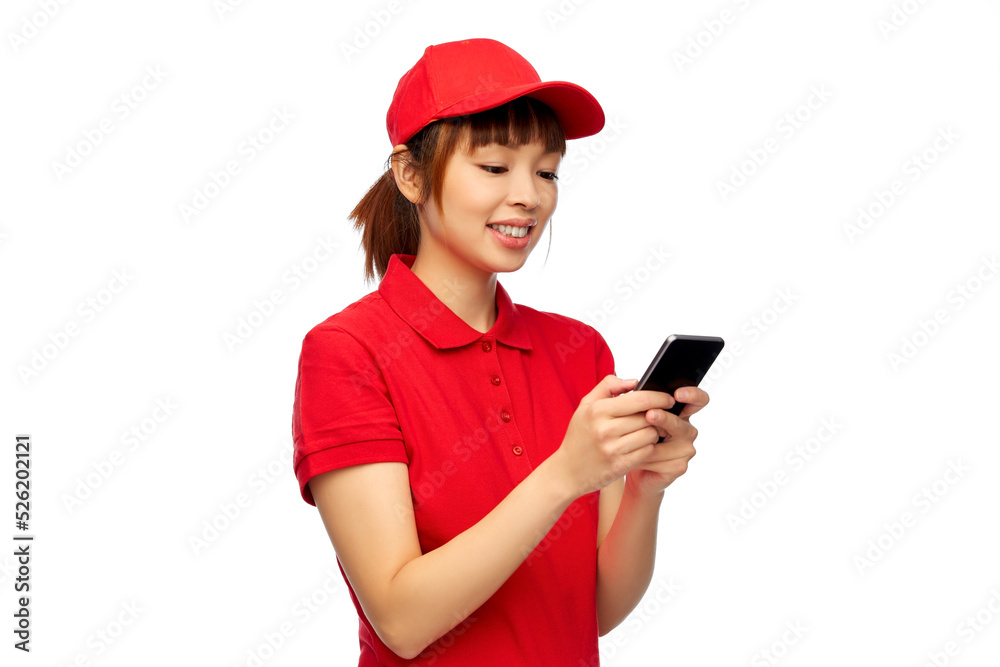 profession, job and people concept - happy smiling delivery woman in red uniform with smartphone over white background profession, job and people concept - happy smiling delivery woman in red uniform with smartphone over white background