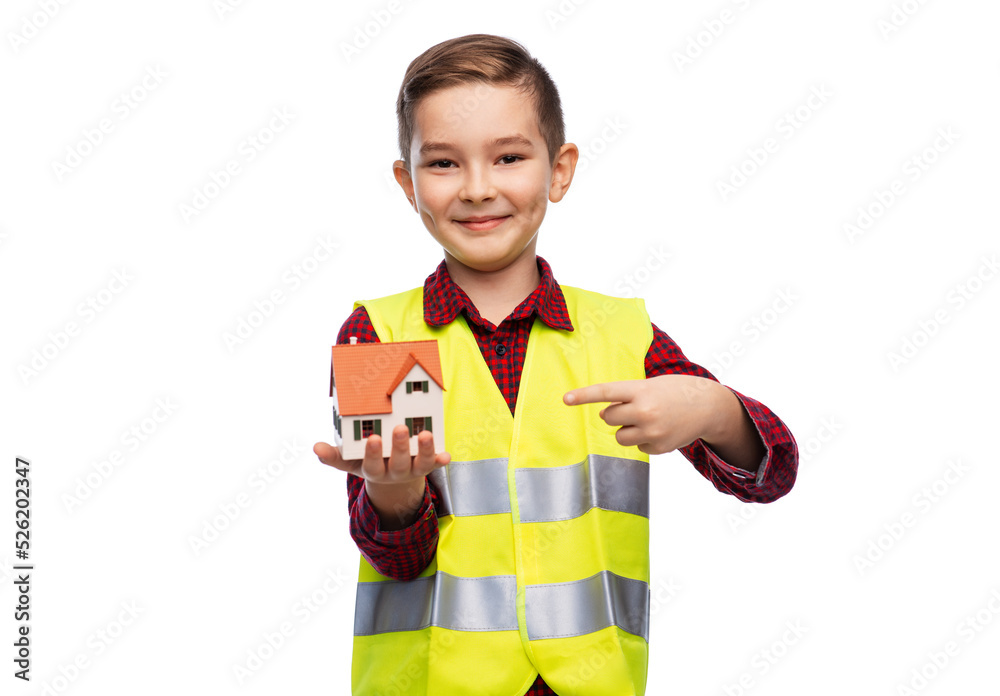building, construction and profession concept - little boy in safety vest showing toy house model over white background building, construction and profession concept - little boy in safety vest showing toy house model over white background