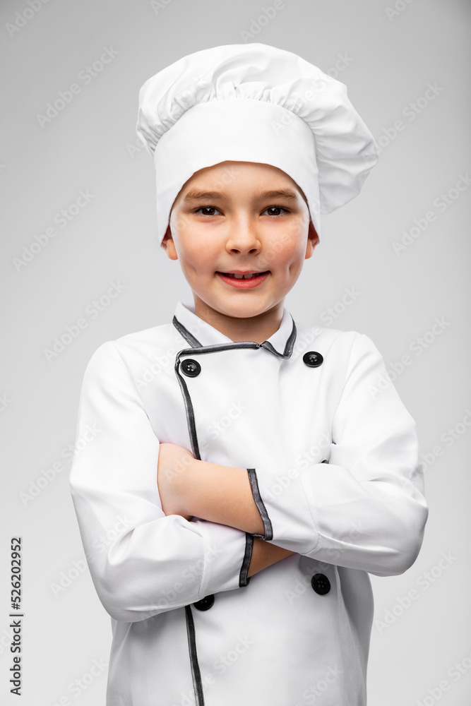 cooking, culinary and profession concept - portrait of happy smiling little boy in chef's toque and jacket over grey background cooking, culinary and profession concept - portrait of happy smiling little boy in chef's toque and jacket over grey background