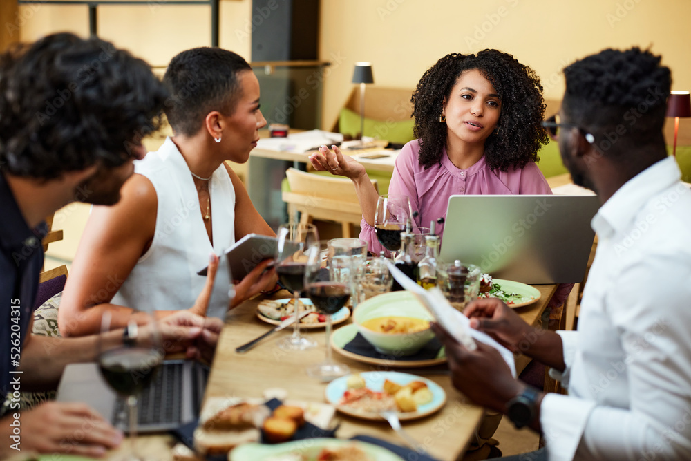 Businesspeople have team building in a restaurant during lunch.