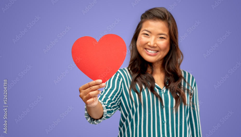 love, charity and valentine's day concept - happy woman with red heart over violet background love, charity and valentine's day concept - happy woman with red heart over violet background