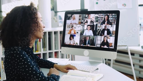 Video conference. Successful African american business woman, sits in front of computer screen, conducts conversation with international colleagues, discusses future project, business strategy, plan