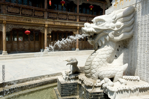 Stone-carved sprinkler dragon in the ancient city of Taierzhuang, Shandong Province, China photo