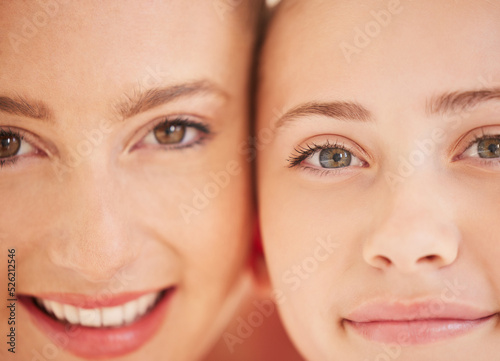 Family  mother and girl child feeling happy and showing sweet smile while standing together. Adoption  relationship and love of a caring mom with her child. Close up of eyes and faces of good dna