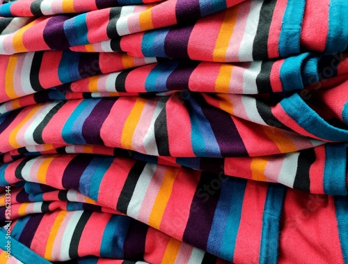 Stack of colorful knitted fabric, knitted winter clothes.