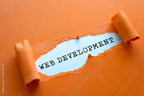 WEB DEVELOPMENT word written under torn paper.