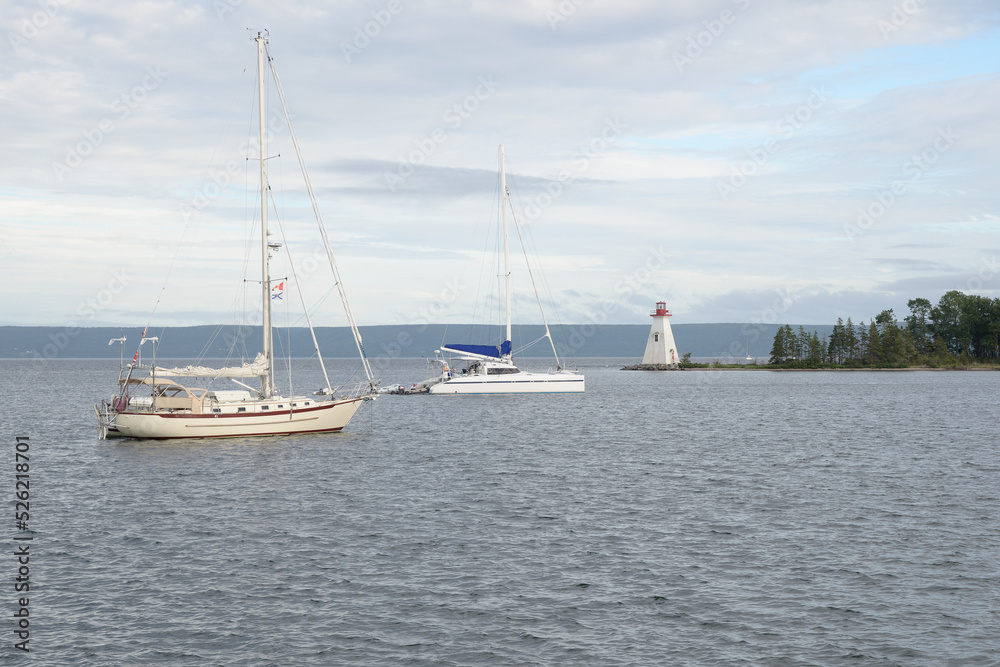 Baddeck, NS on the Bras d'Or lakes, has a small lighthouse and calm waters for sailing