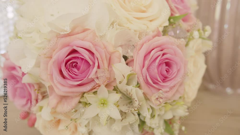 Arranged bouquet of beautiful white and pink roses, tilt up, close up shot. Arranged bouquet of beautiful white and pink roses, tilt up, close up shot.
