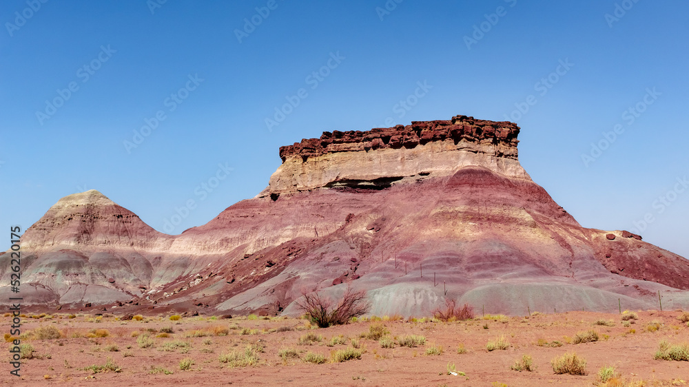 Colorful red rock mountain and dirt field in northern Arizona and Utah desert Colorful red rock mountain and dirt field in northern Arizona and Utah desert