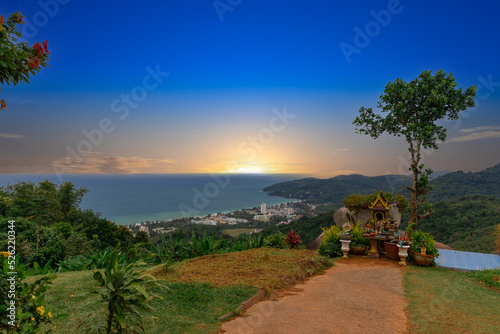 Karon Beach in Phuket Thailand  turquoise blue waters  lush green mountains colourful skies. Phuket is a tropical island many palms