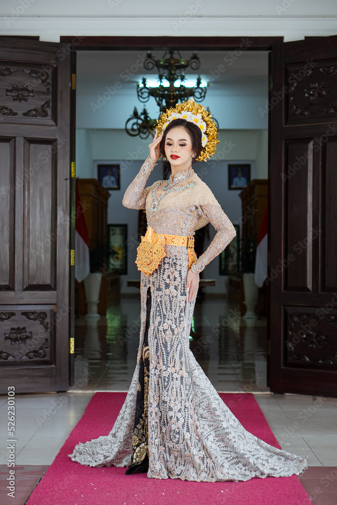 Beautiful Indonesian woman wearing KEBAYA. KEBAYA is a type of upper garment that is