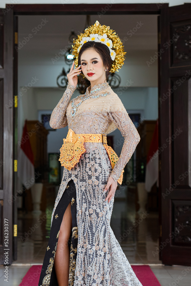 Beautiful Indonesian woman wearing KEBAYA. KEBAYA is a type of upper garment that is