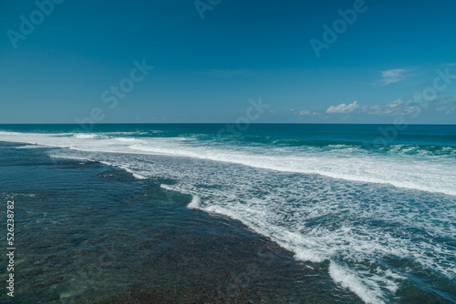 Beautiful beach with white sand and piles of coral in Gunung Kidul, Indonesia, an exotic beach that is still natural and rarely known by tourists