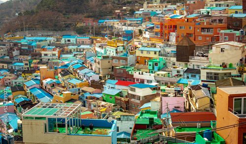 Colorful city village houses and blue roofs view of Gamcheon Cultural Village and mountains in Busan South Korea during sunset © Jacki