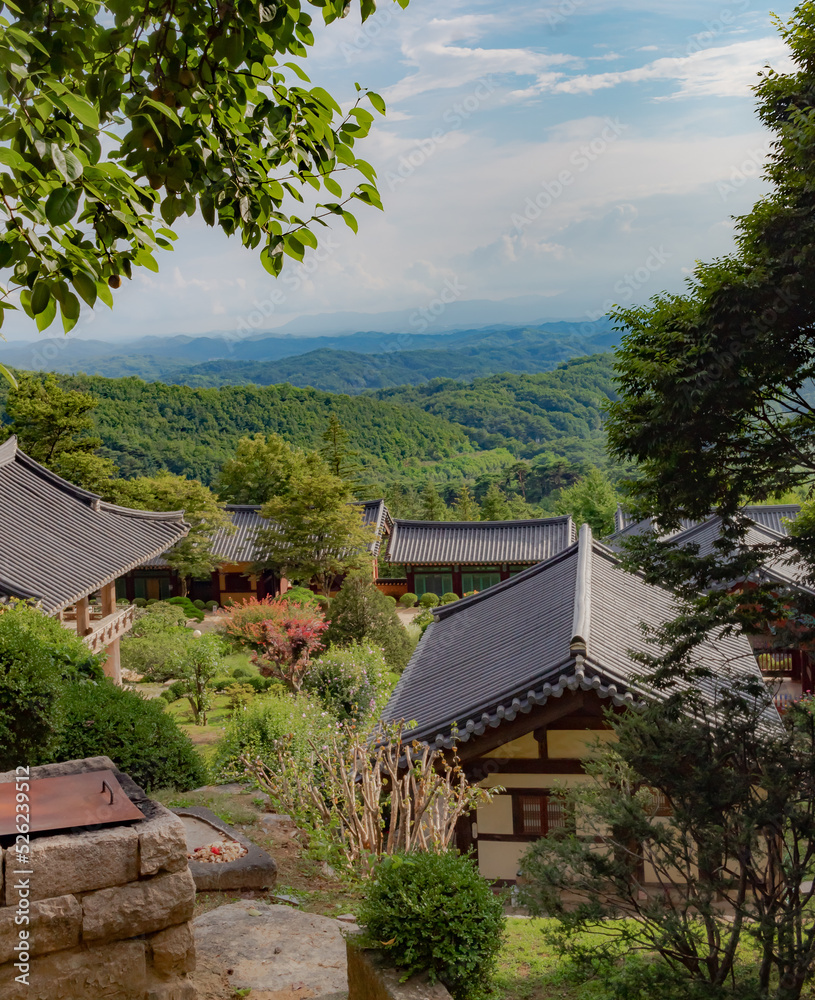 Traditional Korean architecture and lush green forest and mountains at Buseoksa Buddhist temple complex in South Korea on a cloudy day Traditional Korean architecture and lush green forest and mountains at Buseoksa Buddhist temple complex in South Korea on a cloudy day