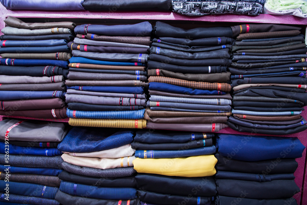 Patterned Textile Fabrics stacked on a retail Shop Shelf for sale Patterned Textile Fabrics stacked on a retail Shop Shelf for sale