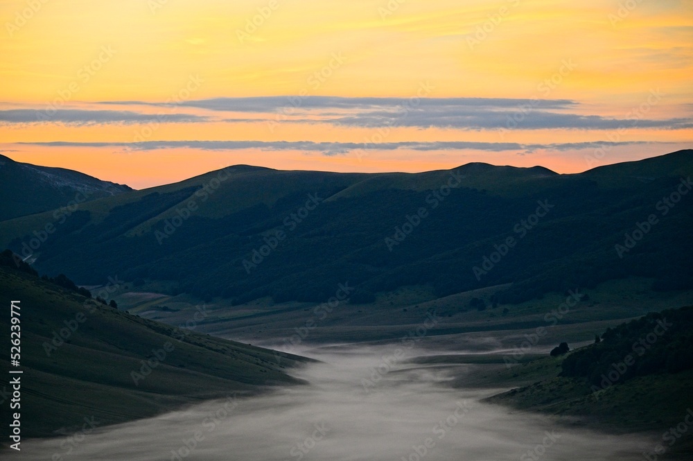 Fog Filled Valley in the Mountains of Italy at Sunrise Fog Filled Valley in the Mountains of Italy at Sunrise