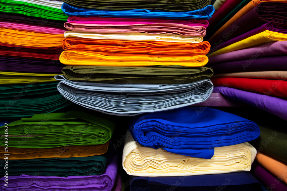Artistic variety shade tone colors Textile Fabrics stacked on retail Shop Shelf to sale