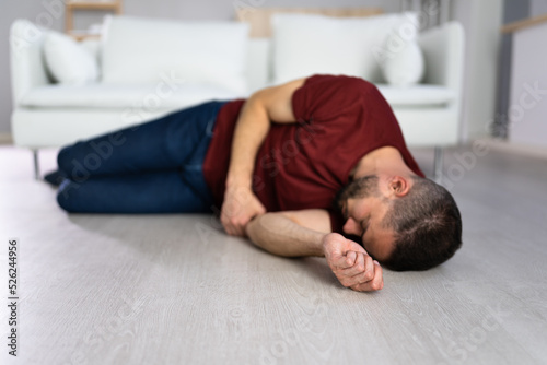Unconscious Young Man Lying On Floor photo