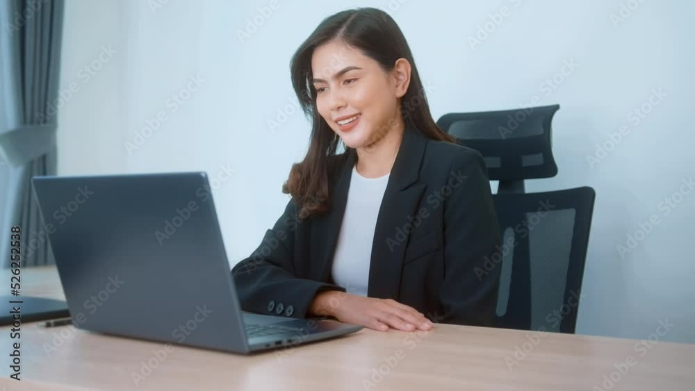 Young beautiful business woman working on laptop with documents in modern office Young beautiful business woman working on laptop with documents in modern office