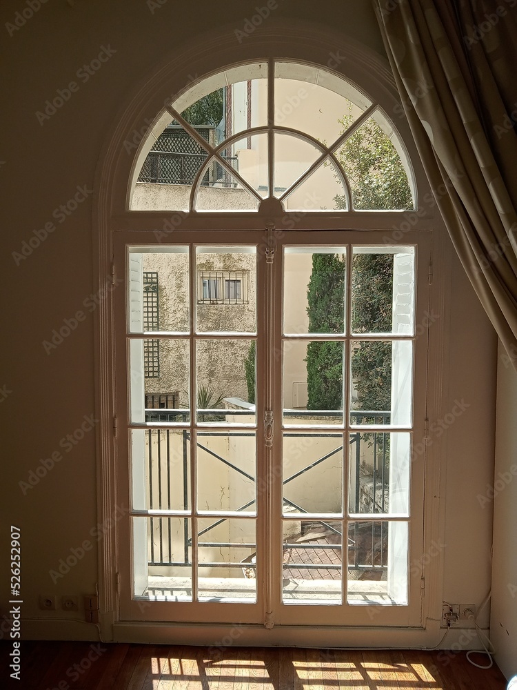 Fototapeta premium Porte-fenêtre demie lune en bois blanc paris hosmanienne