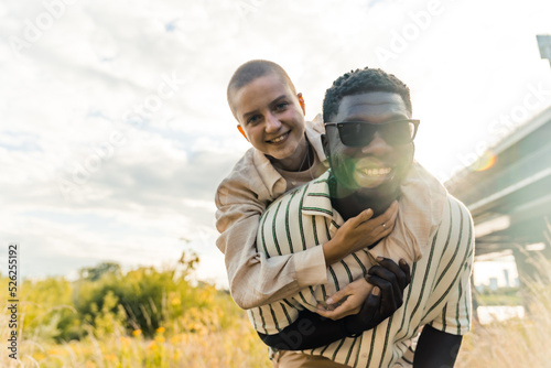multiracial friends enjoying together on a summer trip, medium shot outdoors. High quality photo © PoppyPix