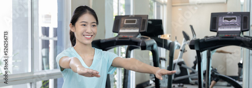 Beautiful and shapely Asian woman working out in the gym, Play exercise machine treadmill, Dumbbell, stretching, Hanging bar, Barbell, Cardio, Stretch, Woman warming up in the gym, Jump rope.