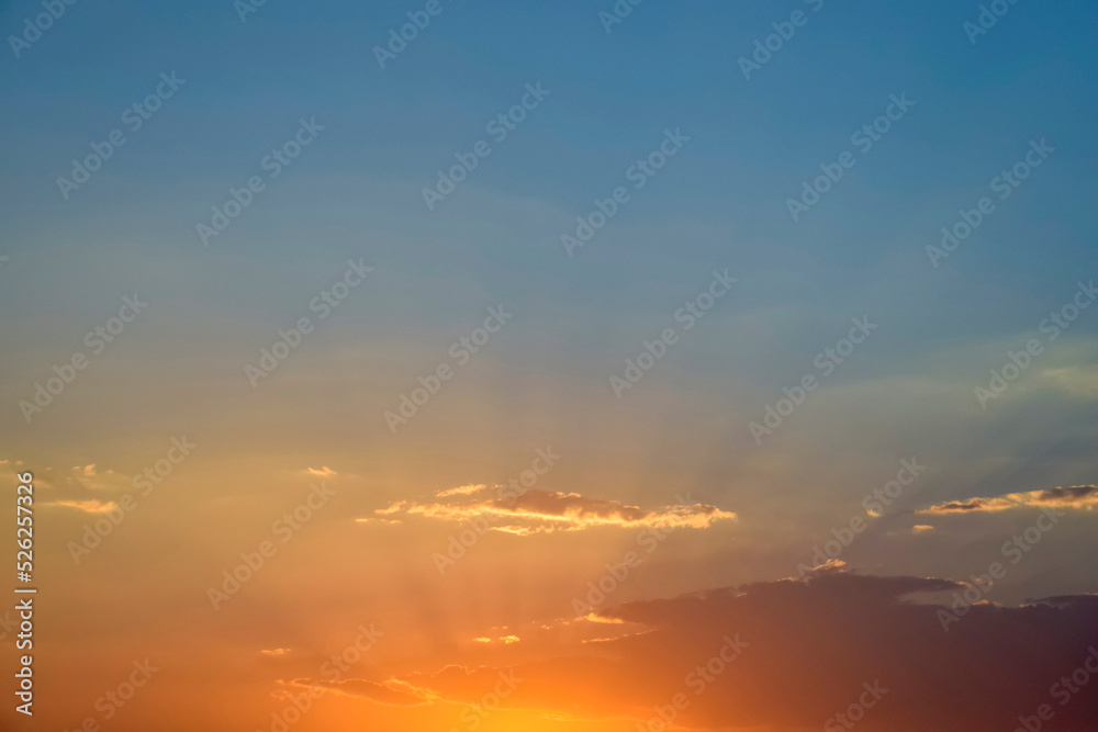 Magnificent bright colorful sky at sunset, nature landscape. Sun's rays break through clouds. Copy space. Soft focus.