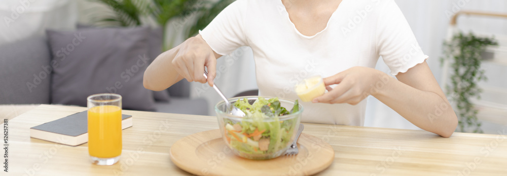 Asian woman making vegetable salad in her home kitchen, Vegetables contain a wide variety of vitamins and minerals, High-fiber and low-calorie diets, Healthy vegetable salad idea, Appetizer concept.