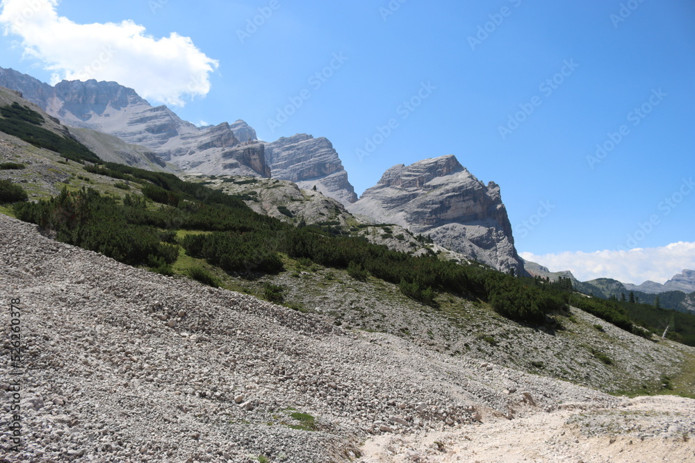 Val Badia, Italy-July 18, 2022: The italian Dolomites behind the small village of Corvara in summer days with beaitiful blue sky in the background. Green nature in the middle of the rocks.