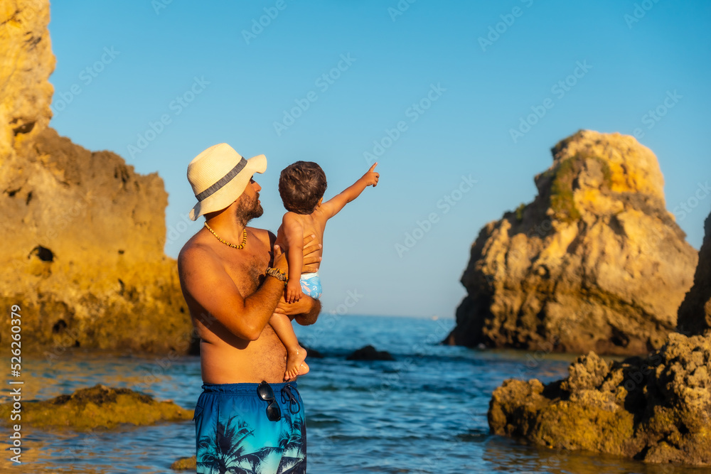 A father with his son on vacation at Praia dos Arrifes, Algarve beach, Albufeira. Portugal
