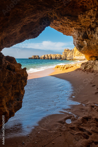 A cave entering the water from the beach at Praia da Coelha, Algarve, Albufeira. Portugal © unai
