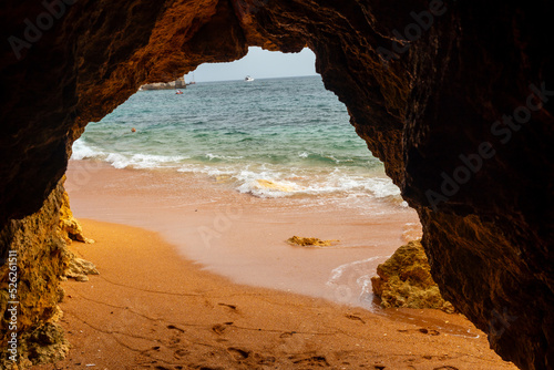Natural cave in the Algarve in summer on the beach at Praia da Coelha, Albufeira. Portugal