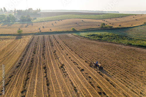 Birdseye view of bean plantation with tractor green fields and trees. Faded background. Agriculture and farming. Horizontal shot. High quality photo