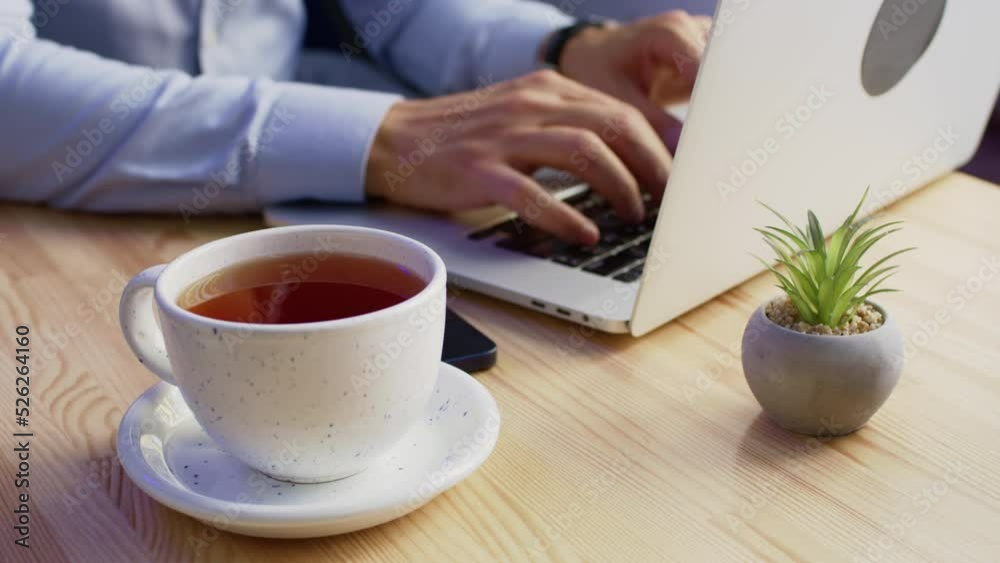 Cup of hot flavored coffee cools down waiting for working freelancer. Self-employed worker types interesting article about tips for business Cup of hot flavored coffee cools down waiting for working freelancer. Self-employed worker types interesting article about tips for business