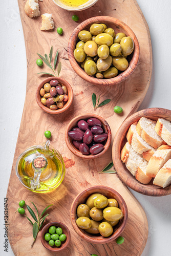 Tasty olives and extra virgin olive oil served with bread.