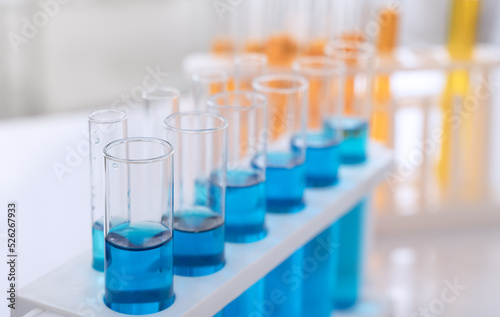 Science laboratory test tubes with blue and orange chemical liquid.