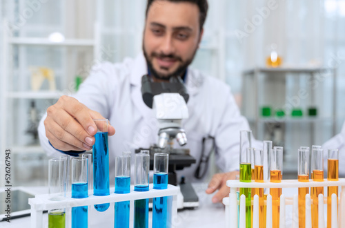 Scientist wearing white laboratory coat and working in scientific research laboratory.